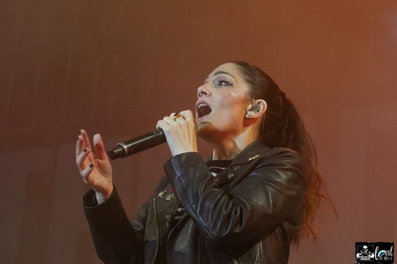 Singer performing on stage, passionately engaging with the audience.