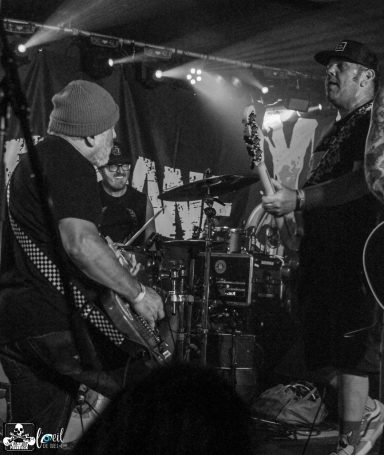 A band performing live on stage with instruments and energy.