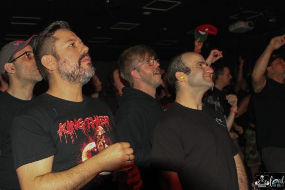 Straightline - L'Anti-Bar & Spectacles A crowd of concertgoers enjoying live music, with diverse expressions of excitement.