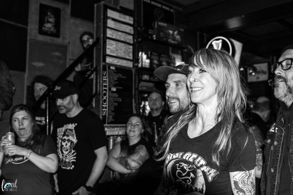 A lively crowd enjoying a performance in a dimly lit venue.