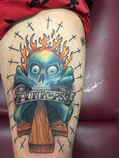 Skull with blue eyes and flames, surrounded by crosses and a wooden cross.