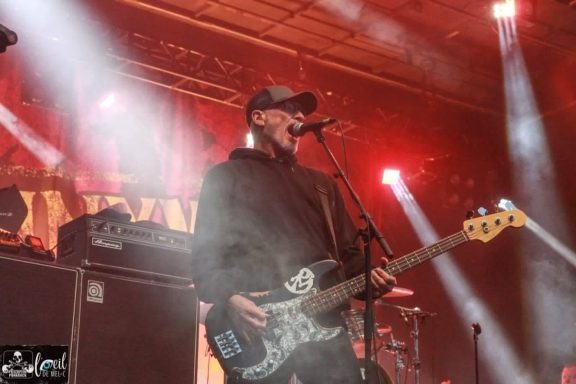 Pennywise - Red Bridge Fest 2026 Musician performing on stage with a bass guitar and microphone, surrounded by dramatic lighting.