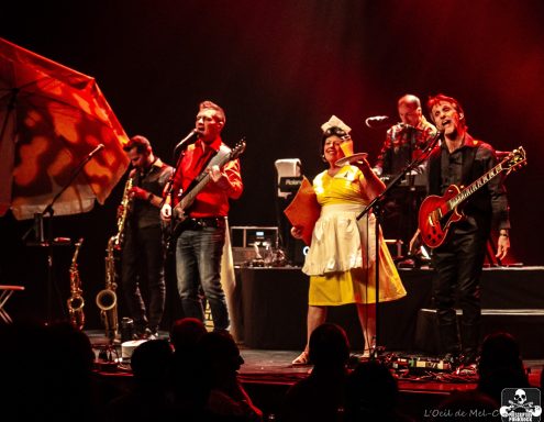 A lively band performing on stage, featuring musicians with various instruments.