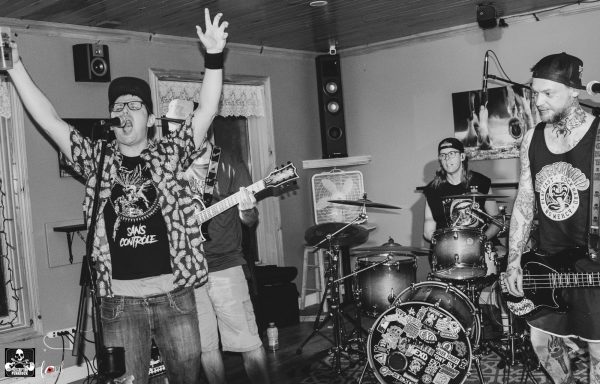 A black and white photo of a live band performing in a small venue.