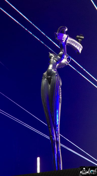 Korn - Quebec, city Sculpture of a stylized woman in a bold pose, illuminated against a dark background.