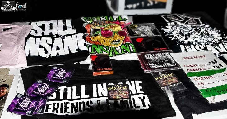 A collection of band merchandise including T-shirts, posters, and flyers.
