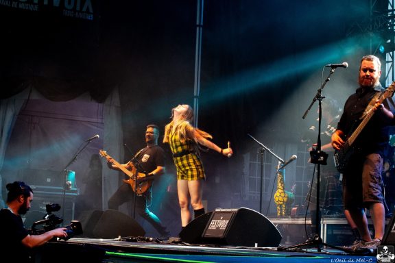 A dynamic live performance featuring musicians on stage with instruments.