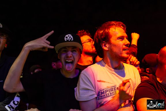 Crowd at a concert, with two young men showing enthusiasm and excitement.