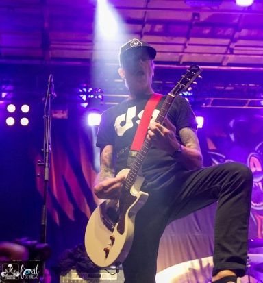 Millencolin - Red Bridge Fest 2026 A guitarist performs on stage with colorful lighting.