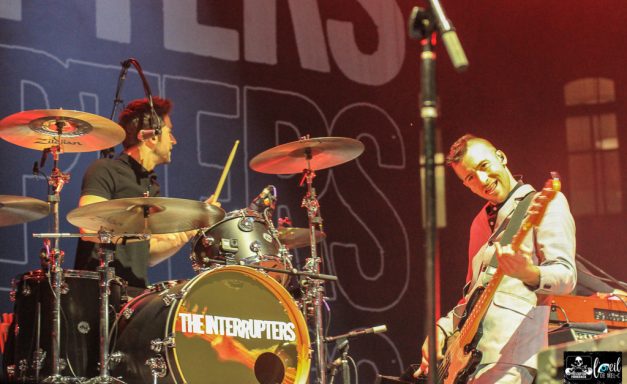 The Interrupters - l'Agora du Port de Québec Drummer and bassist performing on stage with vibrant lighting and energetic atmosphere.