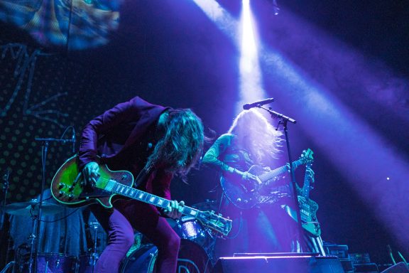 The Damn Truth - Centre Videotron Two guitarists perform energetically on stage with dramatic lighting.