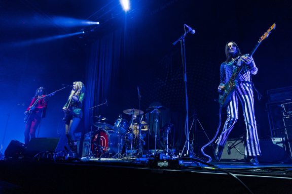 The Damn Truth - Centre Videotron A lively band performs on stage with dynamic lighting and colorful outfits.