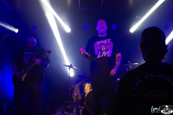 A band performing on stage with bright lights and a lively atmosphere.