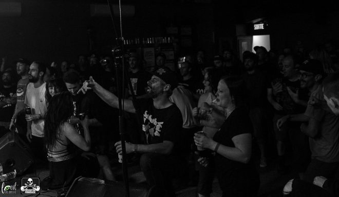 A lively crowd at a concert, with people enjoying the performance.