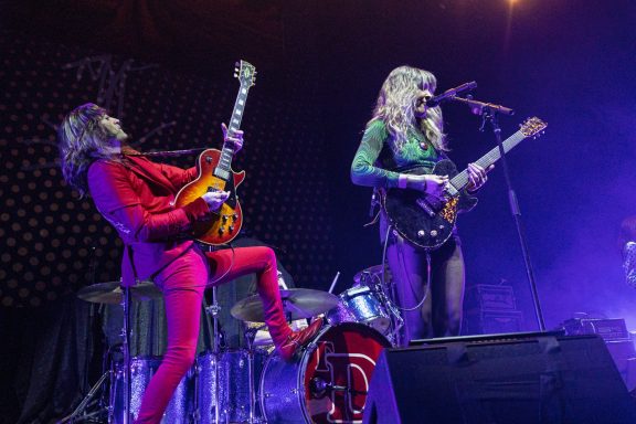 The Damn Truth - Centre Videotron Two musicians perform on stage; one plays guitar while the other sings. Colorful lighting illuminates them.