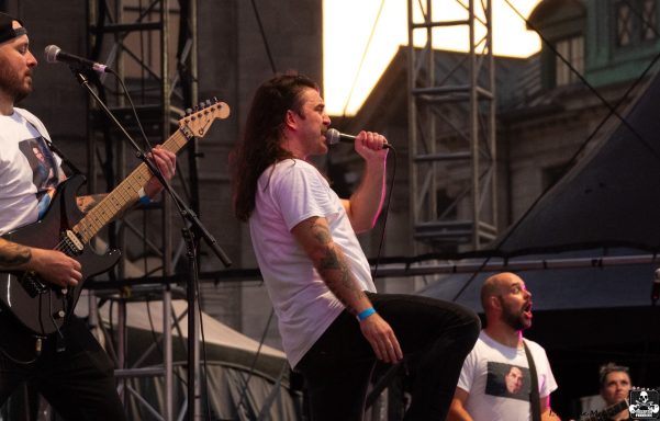 Band performing on stage with energizing vibes during a concert.