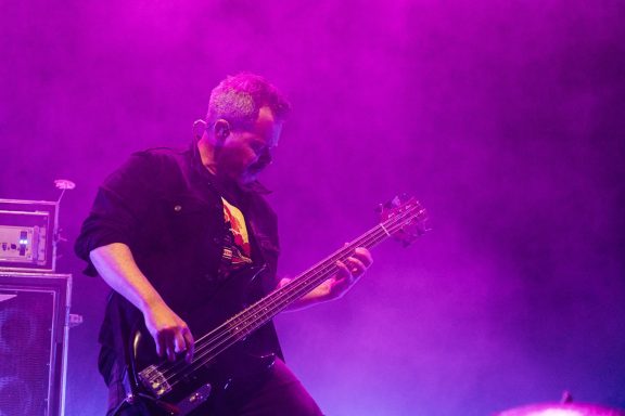 Big Wreck - Centre Videotron A musician playing bass guitar under purple stage lighting.