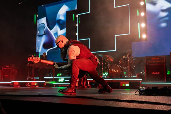 +LIVE+ - Centre Videotron Musician performing on stage with dynamic lighting and a vibrant backdrop.