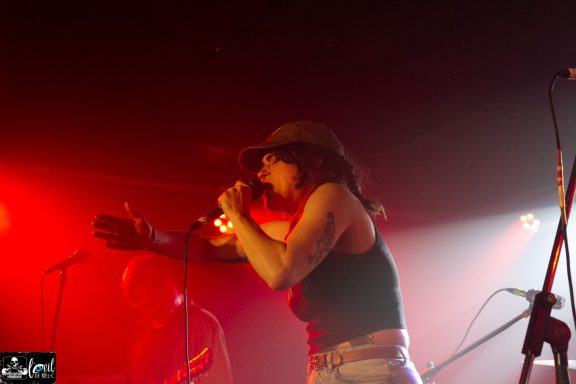 Mvll Crimes - La Source de la Martinière Singer performing on stage with dynamic lighting and expressive gestures.