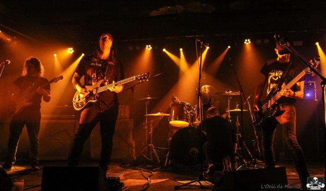A live band performing on stage with dynamic lighting effects.